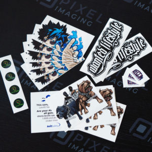 Various custom-printed and machine-cut vinyl stickers and decals. Product labels, hard hat stickers, anime vehicle decals, gangsta vinyl stickers.