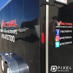Company logo decals, vinyl lettering, and social media decals on a black work tool trailer.