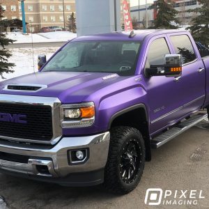 A pearlescent-purple color-change vinyl vehicle wrap installed on a GMC 3500 HD pickup truck.