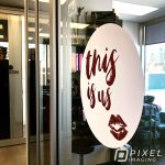 Window Decals & Graphics Calgary: A newly-installed window decal bearing the text "this is us" at a Calgary business.